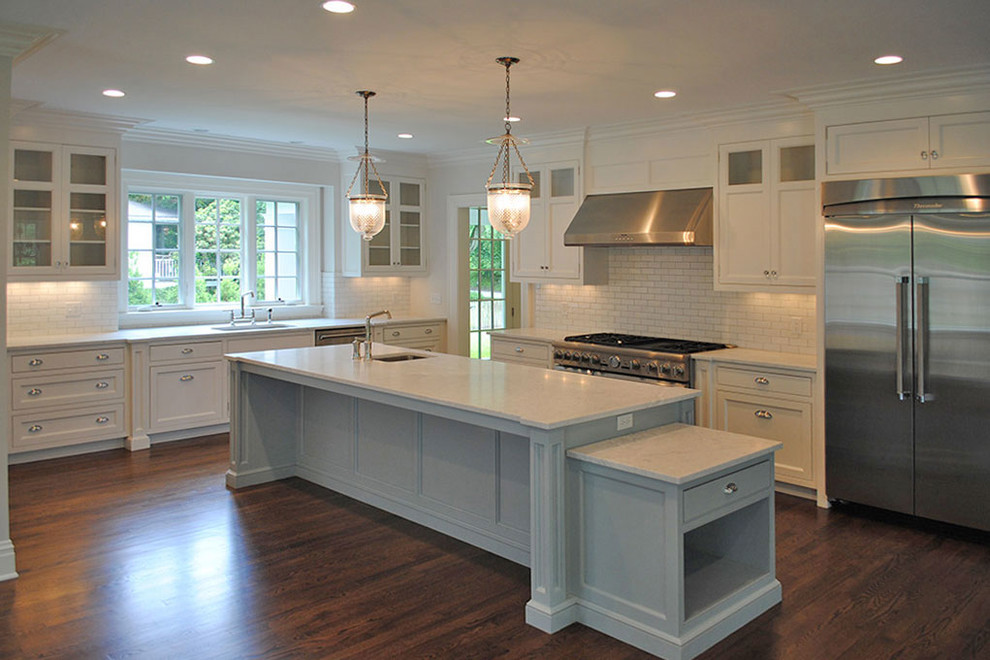 Eat-in kitchen - large transitional l-shaped dark wood floor and brown floor eat-in kitchen idea with an undermount sink, shaker cabinets, white cabinets, stainless steel appliances and an island