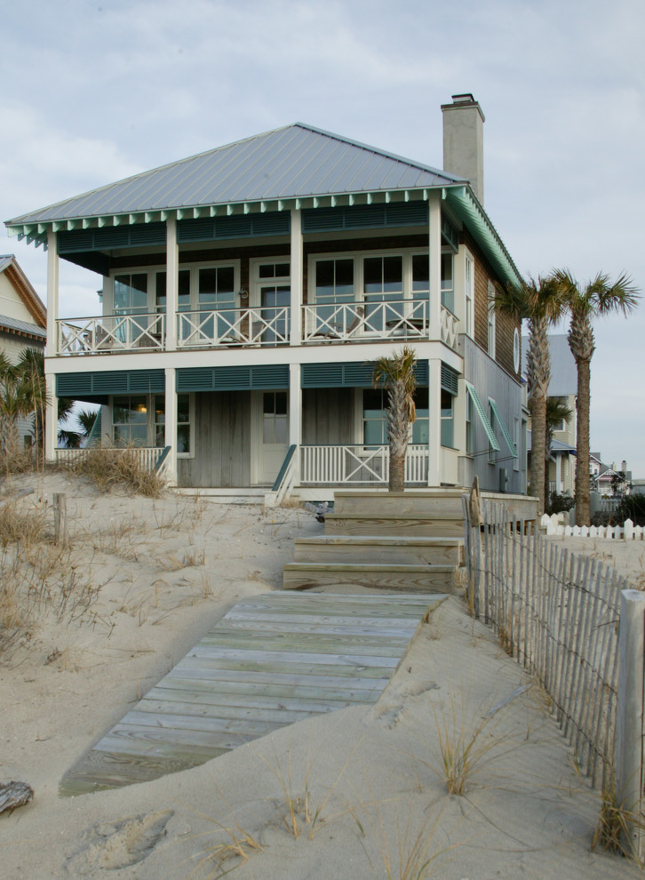 Design ideas for a mid-sized beach style two-storey exterior in Wilmington with a hip roof.