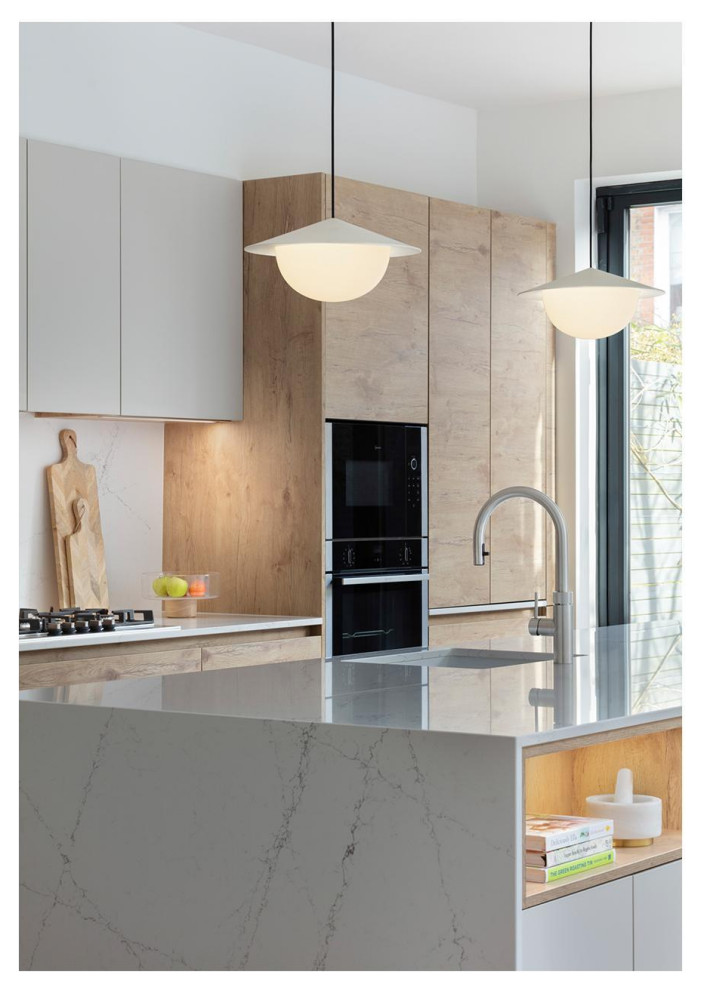 Inspiration for a large scandinavian open plan kitchen in London with an integrated sink, flat-panel cabinets, medium wood cabinets, quartzite benchtops, white splashback, engineered quartz splashback, stainless steel appliances, medium hardwood floors, with island, brown floor and white benchtop.