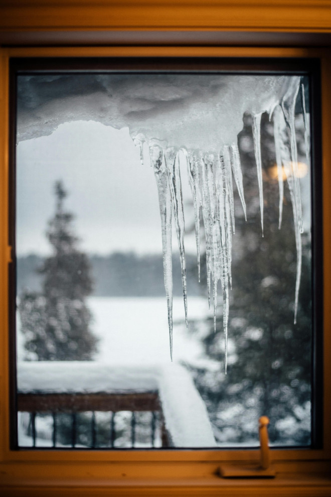 Ice and Snow Build Up on rooftop showing through the window of the home