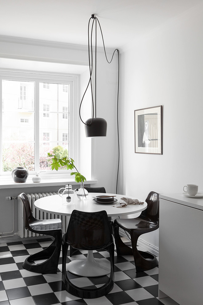 Mid-sized scandinavian separate dining room in Gothenburg with white walls, ceramic floors and no fireplace.