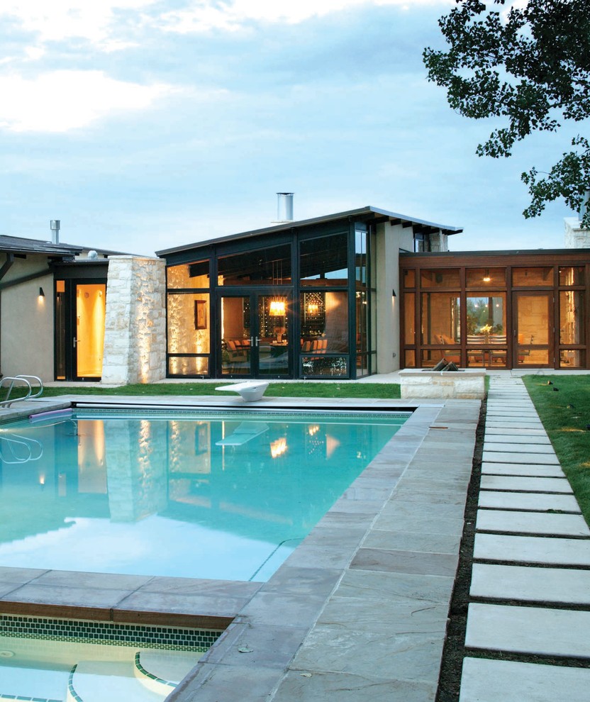 Design ideas for a contemporary rectangular pool in Denver with concrete pavers.