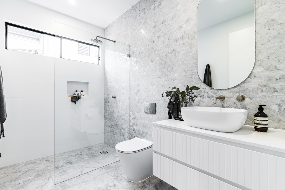 Inspiration for a large beach style 3/4 bathroom in Sydney with flat-panel cabinets, white cabinets, a curbless shower, gray tile, a vessel sink, grey floor, an open shower, white benchtops, a niche, a single vanity and a floating vanity.
