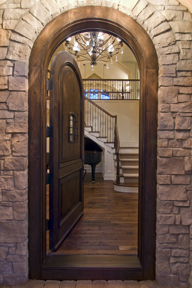 This is an example of a traditional entryway in Minneapolis with a single front door and a dark wood front door.