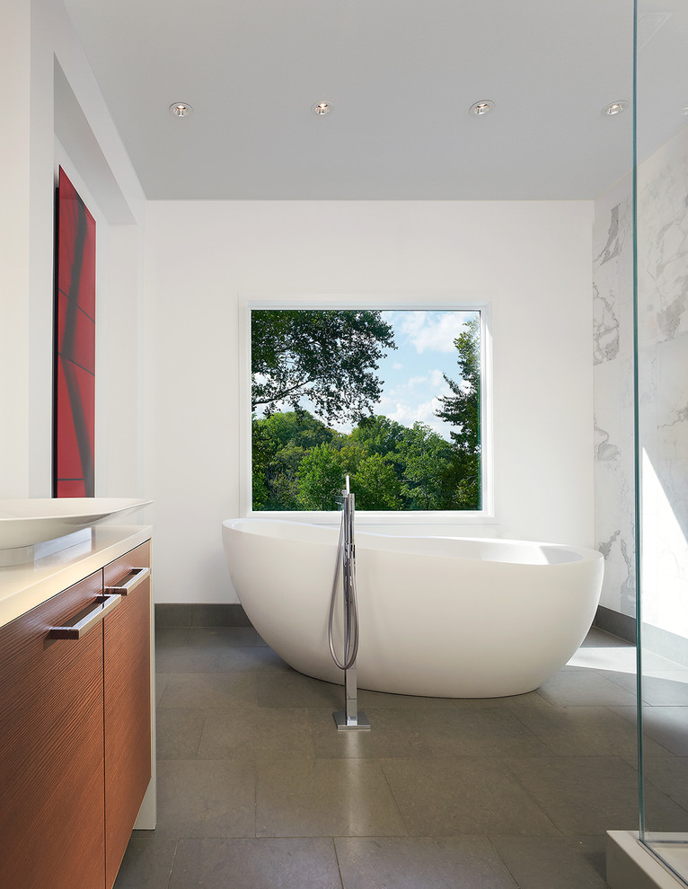 Design ideas for a modern bathroom in DC Metro with a vessel sink and a freestanding tub.