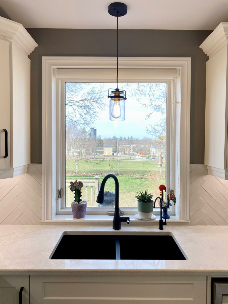 Mid-sized transitional l-shaped enclosed kitchen photo with a double-bowl sink, recessed-panel cabinets, white cabinets, gray backsplash, glass tile backsplash and no island