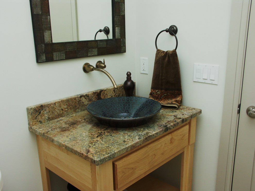 Photo of a contemporary powder room in Other with open cabinets, light wood cabinets, white walls, a vessel sink and granite benchtops.