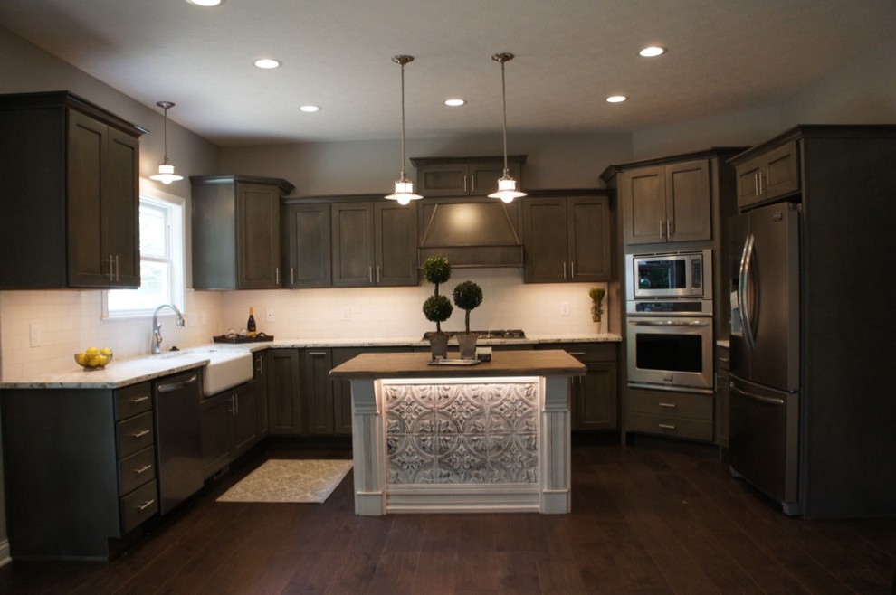 Inspiration for a transitional u-shaped eat-in kitchen remodel with flat-panel cabinets, white backsplash, stainless steel appliances and an island