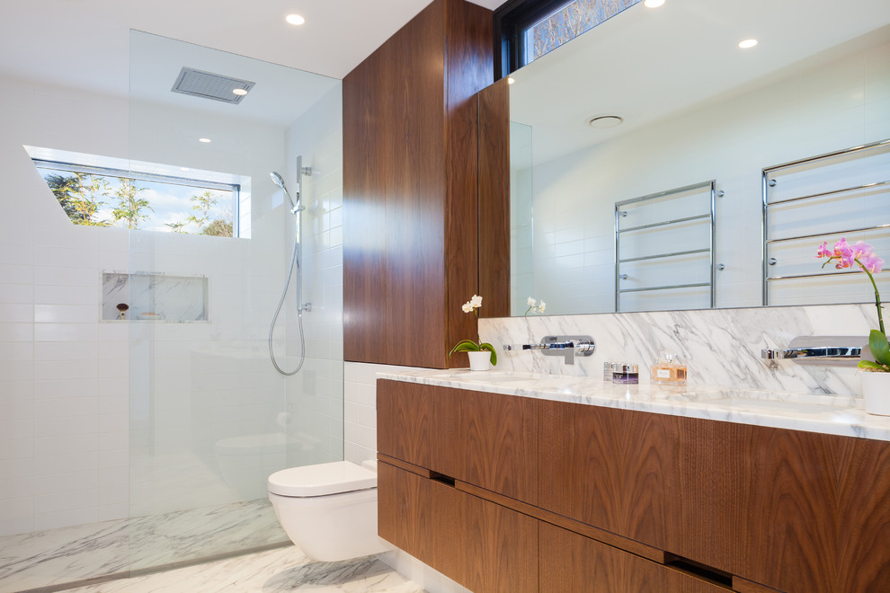 Inspiration for a mid-sized contemporary master bathroom in Sydney with medium wood cabinets, a wall-mount toilet, white tile, ceramic tile, white walls, marble floors, an undermount sink, marble benchtops, an alcove shower and an open shower.