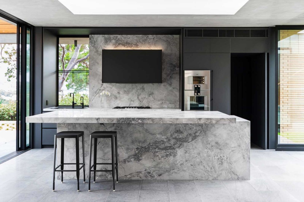 Inspiration for a large contemporary galley kitchen in Sydney with an undermount sink, black cabinets, marble benchtops, grey splashback, marble splashback, stainless steel appliances, with island, grey floor, grey benchtop and flat-panel cabinets.
