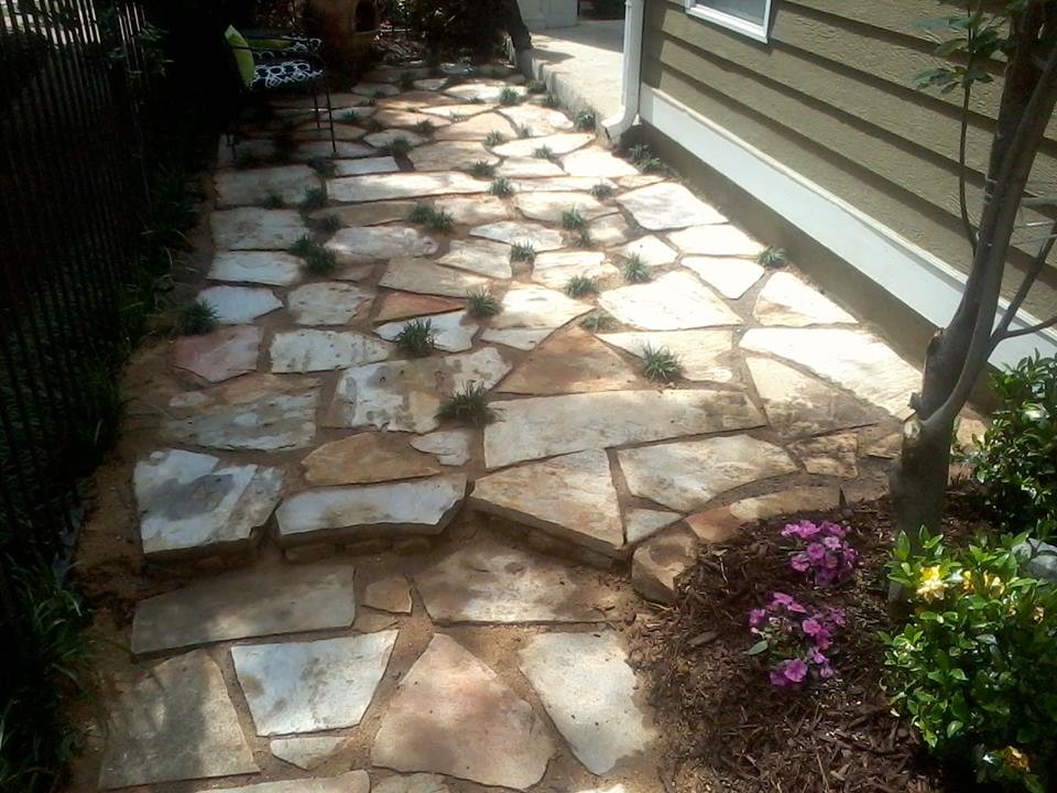 Example of a small transitional backyard stone patio design with no cover
