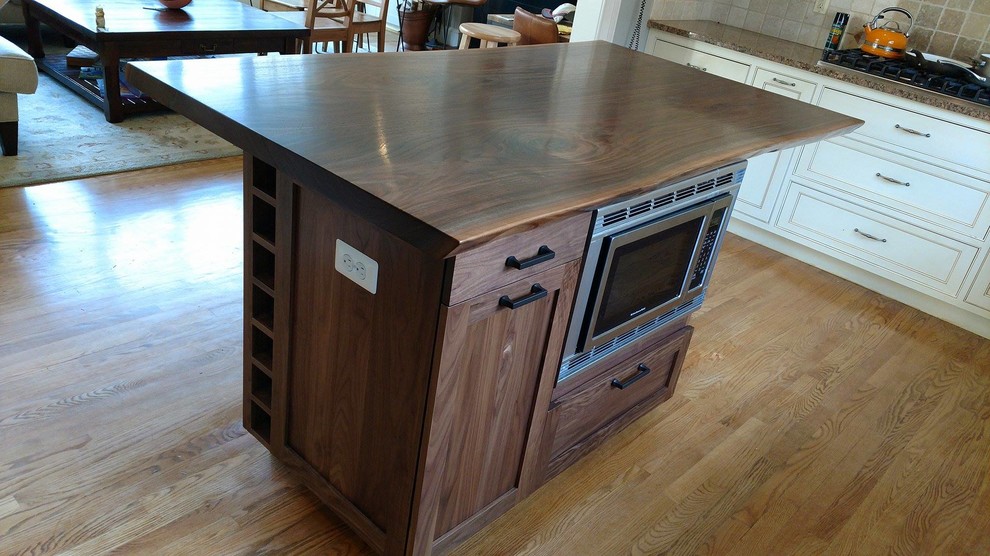 Mid-sized mountain style l-shaped medium tone wood floor and brown floor open concept kitchen photo in DC Metro with an undermount sink, beaded inset cabinets, dark wood cabinets, wood countertops, beige backsplash, ceramic backsplash, stainless steel appliances and an island