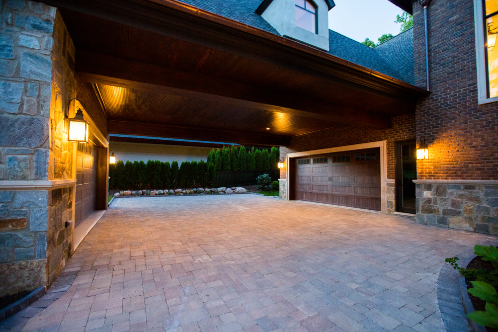This is an example of an expansive traditional attached four-car porte cochere in Detroit.