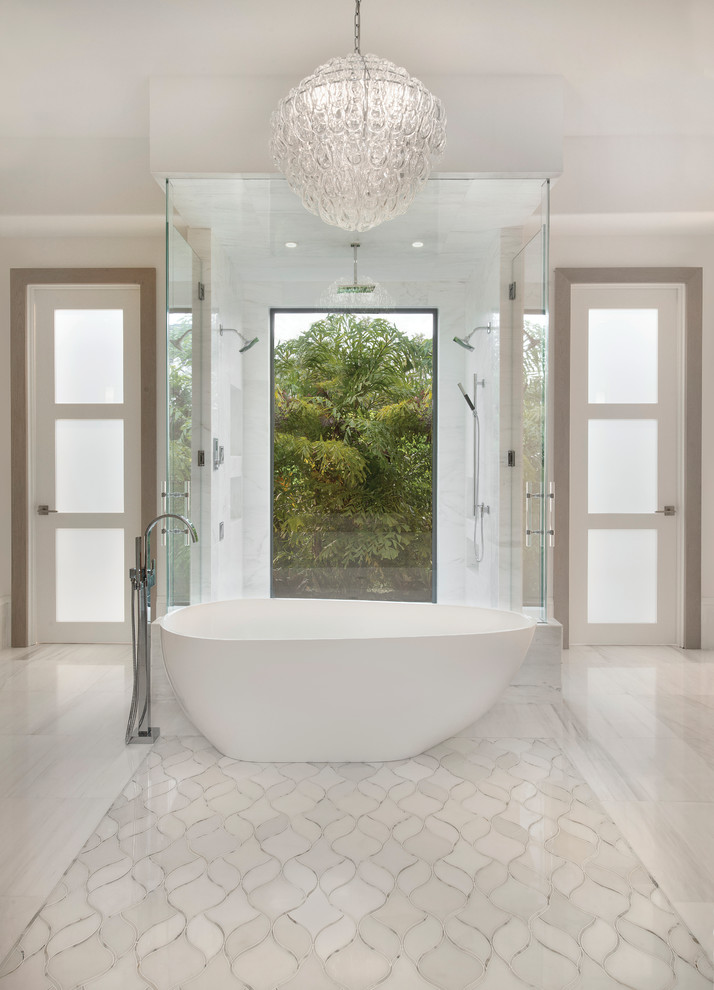 Bathroom in Miami with a freestanding tub, an alcove shower, white tile, white walls and marble floors.