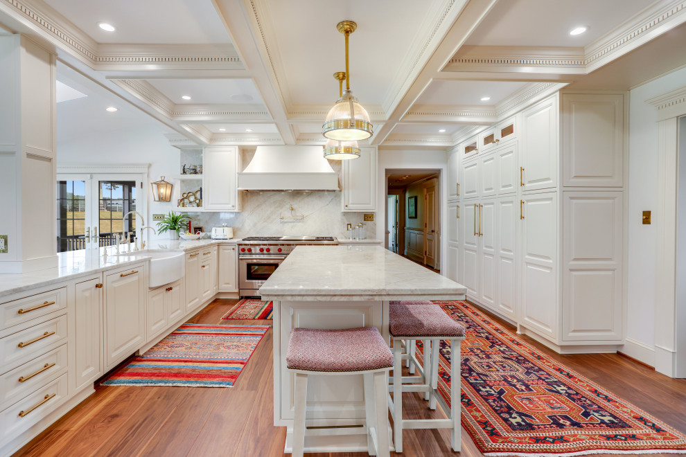 Inspiration for a large traditional u-shaped eat-in kitchen in DC Metro with a farmhouse sink, raised-panel cabinets, white cabinets, granite benchtops, granite splashback, stainless steel appliances and with island.