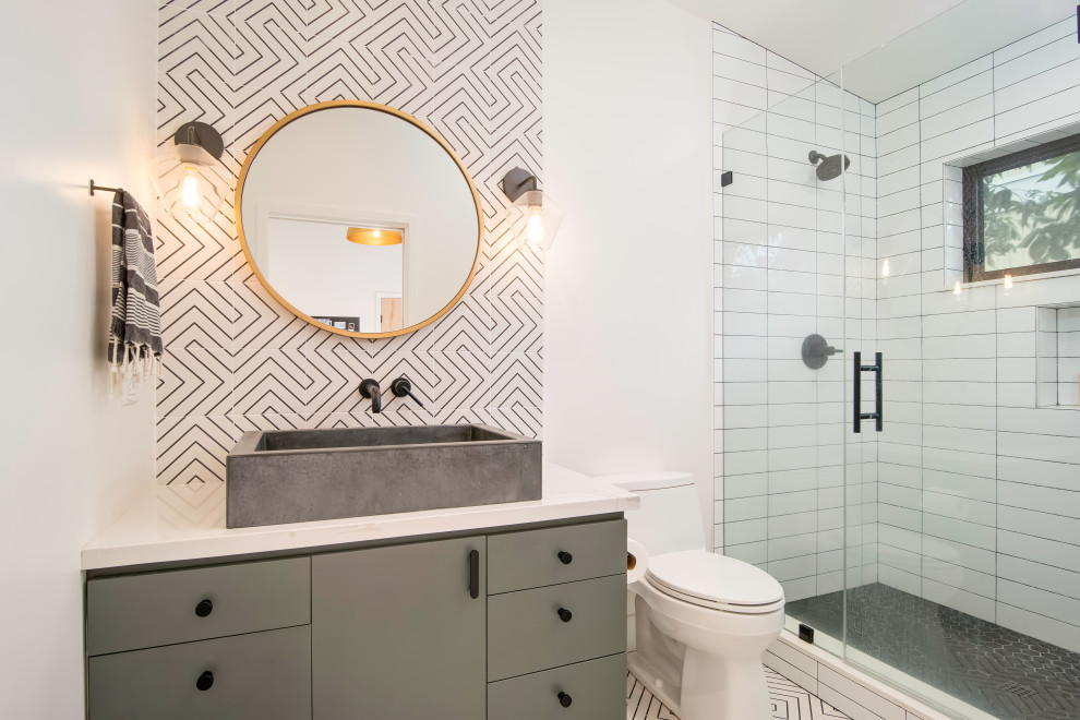 Inspiration for a mid-sized contemporary 3/4 bathroom in Orange County with flat-panel cabinets, grey cabinets, an alcove shower, white tile, cement tile, white walls, cement tiles, a trough sink, engineered quartz benchtops, white floor, a hinged shower door and white benchtops.