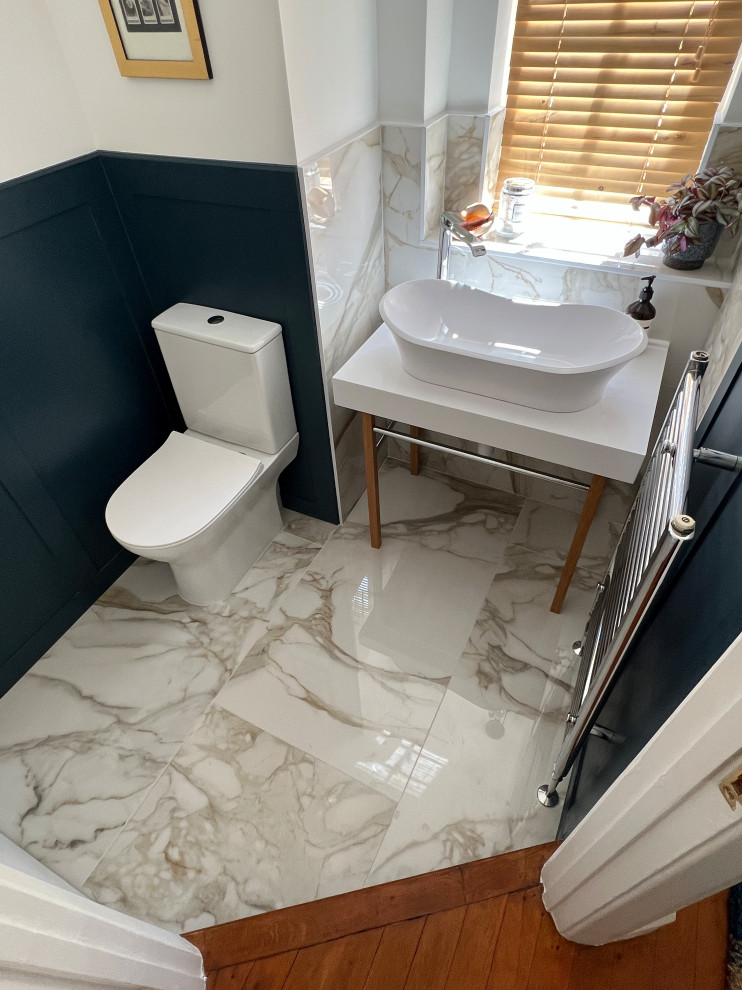 Inspiration for a medium sized contemporary cloakroom in London with a two-piece toilet, blue tiles, porcelain flooring, a pedestal sink, engineered stone worktops, white worktops and a freestanding vanity unit.