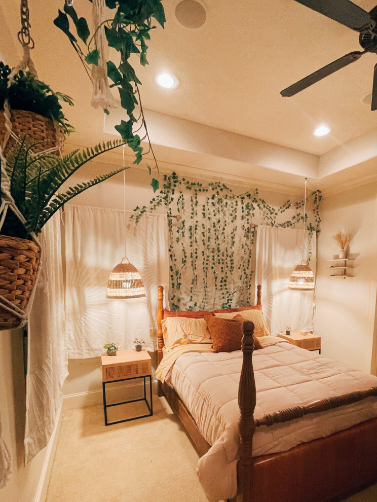 Mid-sized tropical bedroom in Houston with beige walls, carpet and beige floor.