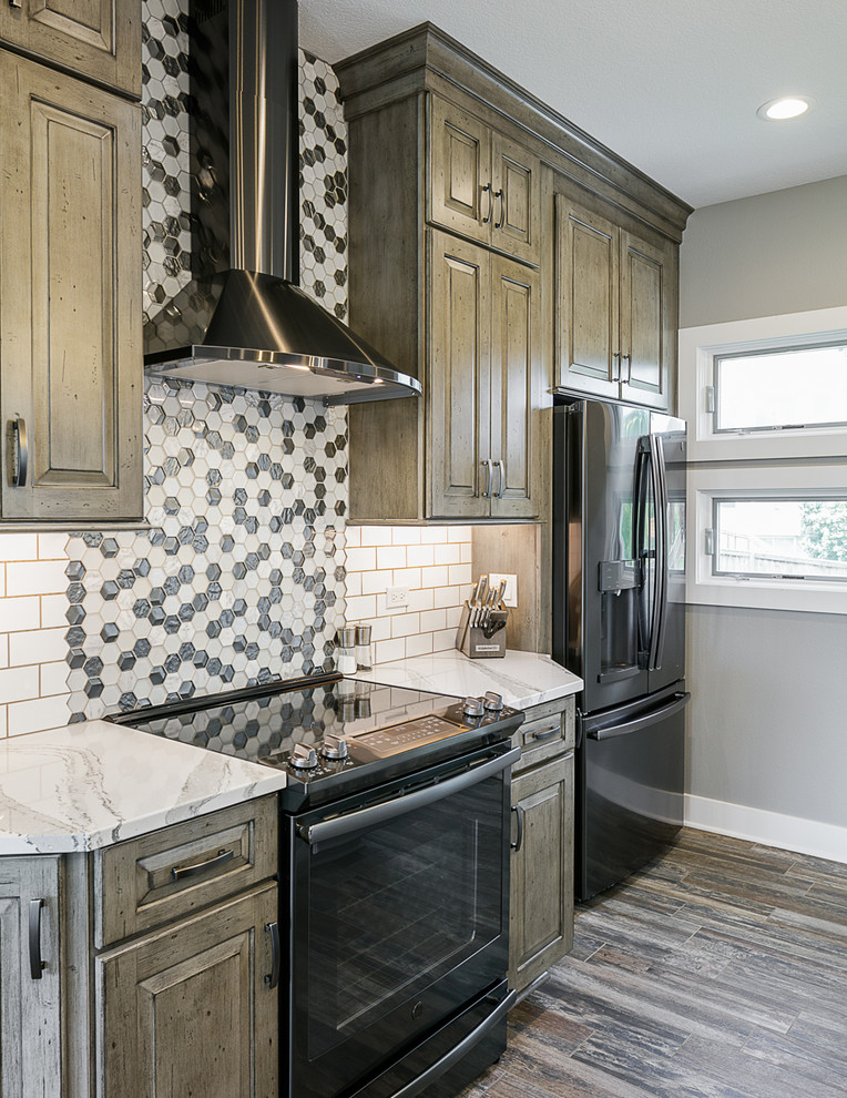 Inspiration for a mid-sized transitional single-wall ceramic tile and multicolored floor eat-in kitchen remodel with a farmhouse sink, raised-panel cabinets, distressed cabinets, quartz countertops, white backsplash, subway tile backsplash, black appliances, an island and white countertops