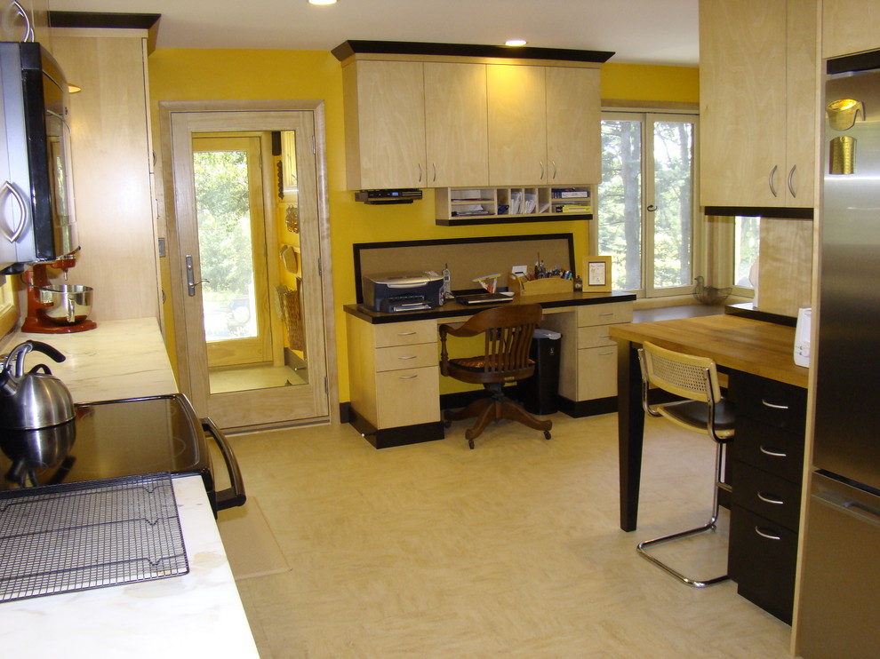 Large midcentury u-shaped separate kitchen in Portland Maine with an integrated sink, flat-panel cabinets, light wood cabinets, wood benchtops, stainless steel appliances, linoleum floors and no island.