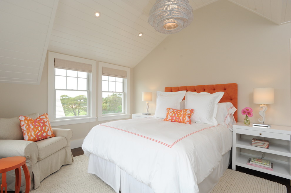 This is an example of a beach style bedroom in Boston with beige walls, dark hardwood floors and no fireplace.