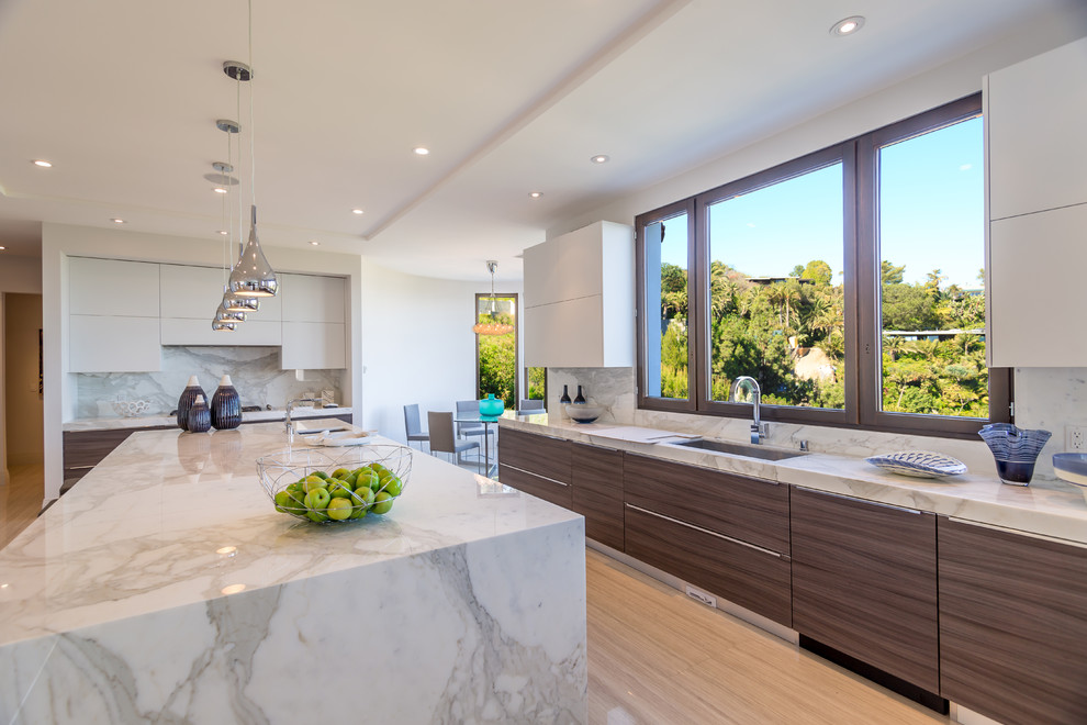 This is an example of a contemporary eat-in kitchen in Los Angeles with a single-bowl sink, flat-panel cabinets, brown cabinets, marble benchtops, multi-coloured splashback, stone slab splashback, white appliances, porcelain floors and with island.