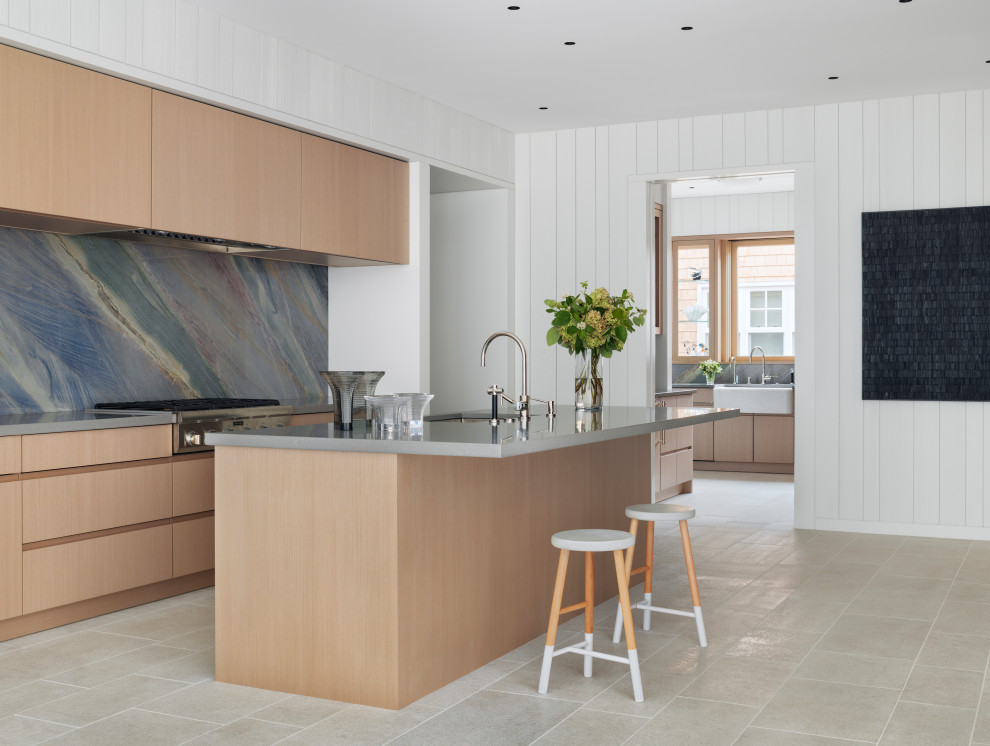 Design ideas for a beach style single-wall kitchen in San Francisco with an undermount sink, flat-panel cabinets, light wood cabinets, multi-coloured splashback, stainless steel appliances, porcelain floors, with island, grey floor and grey benchtop.