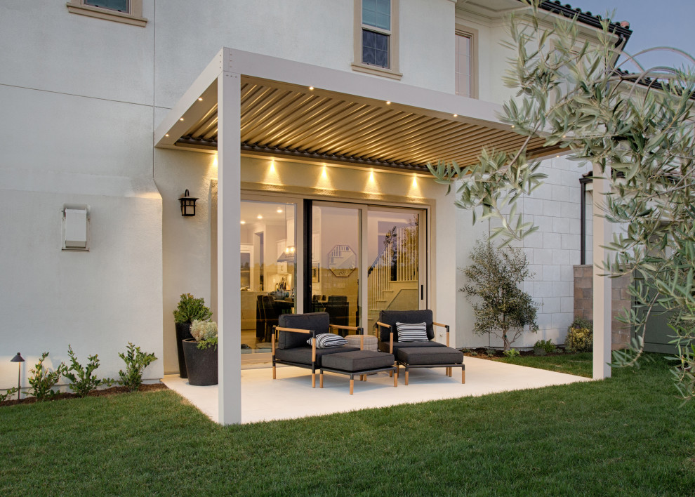 Design ideas for a small contemporary side yard patio in Orange County with concrete slab and a pergola.