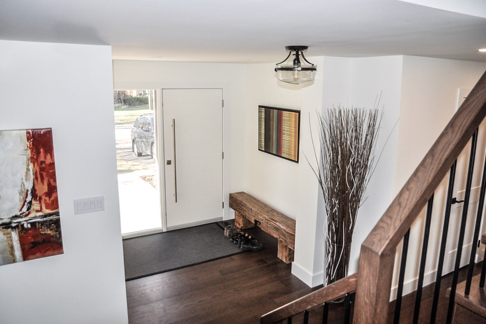Inspiration for a mid-sized transitional dark wood floor and brown floor foyer remodel with white walls and a white front door