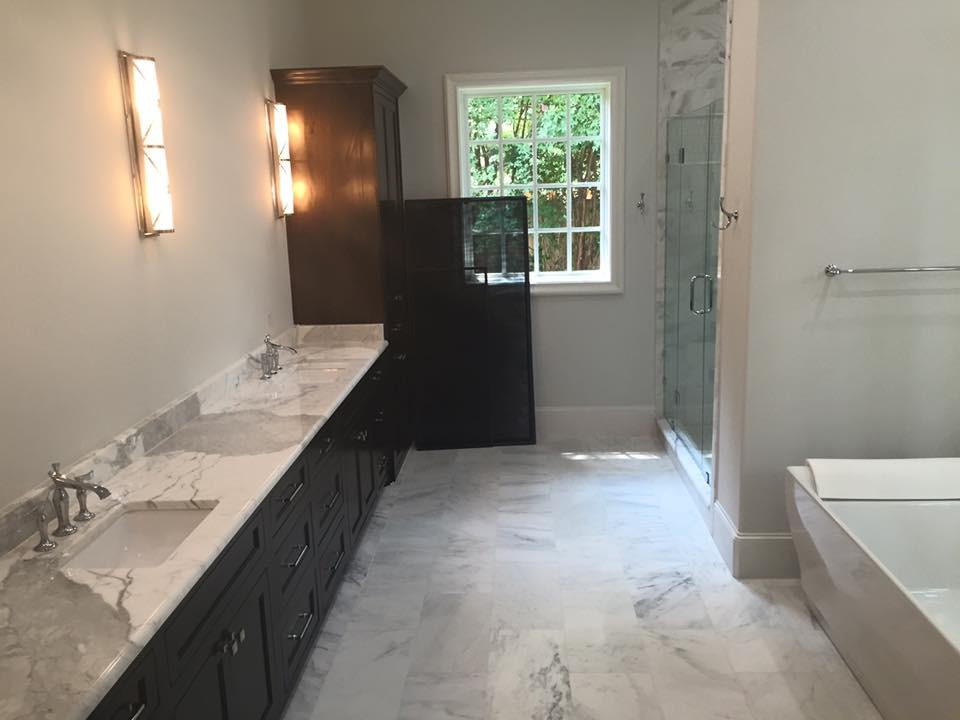 Mid-sized transitional master ceramic tile freestanding bathtub photo in Dallas with recessed-panel cabinets, black cabinets, white walls, an undermount sink and marble countertops