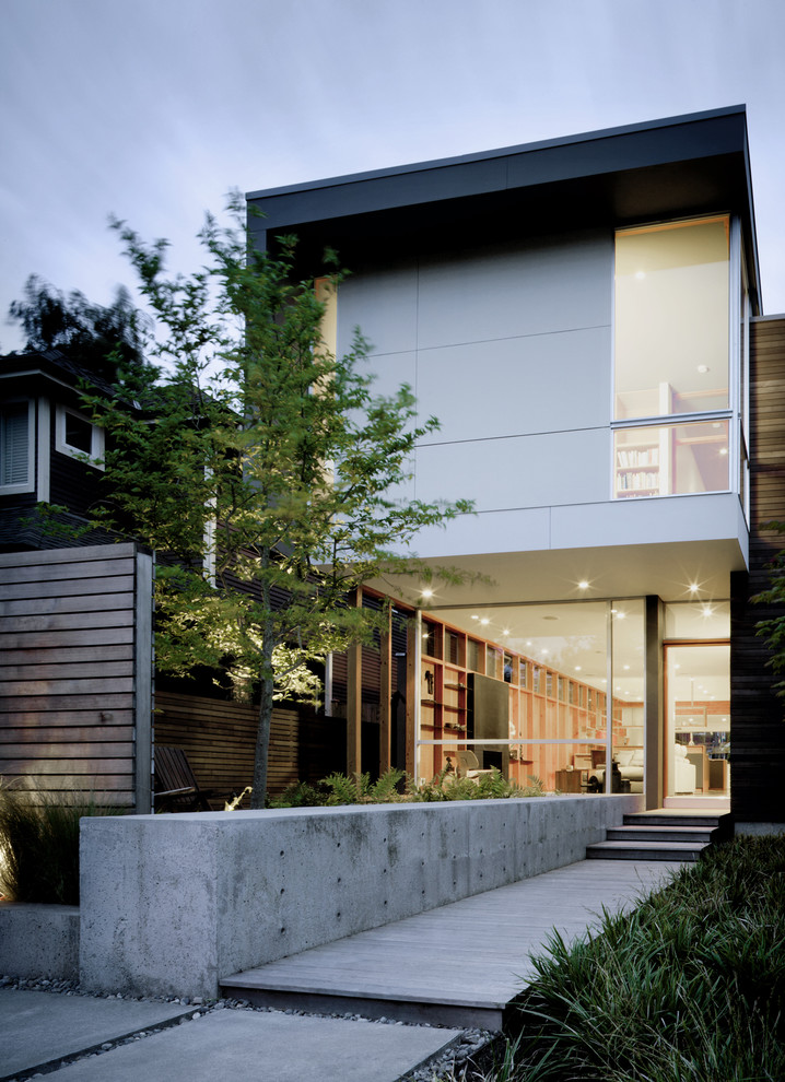 Photo of a contemporary two-storey exterior in Seattle with mixed siding.