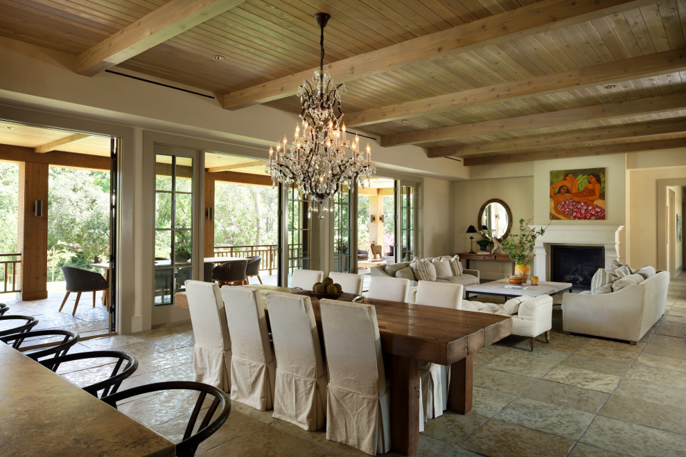 Mid-sized country dining room in San Francisco with beige walls, limestone floors, beige floor, wood and exposed beam.
