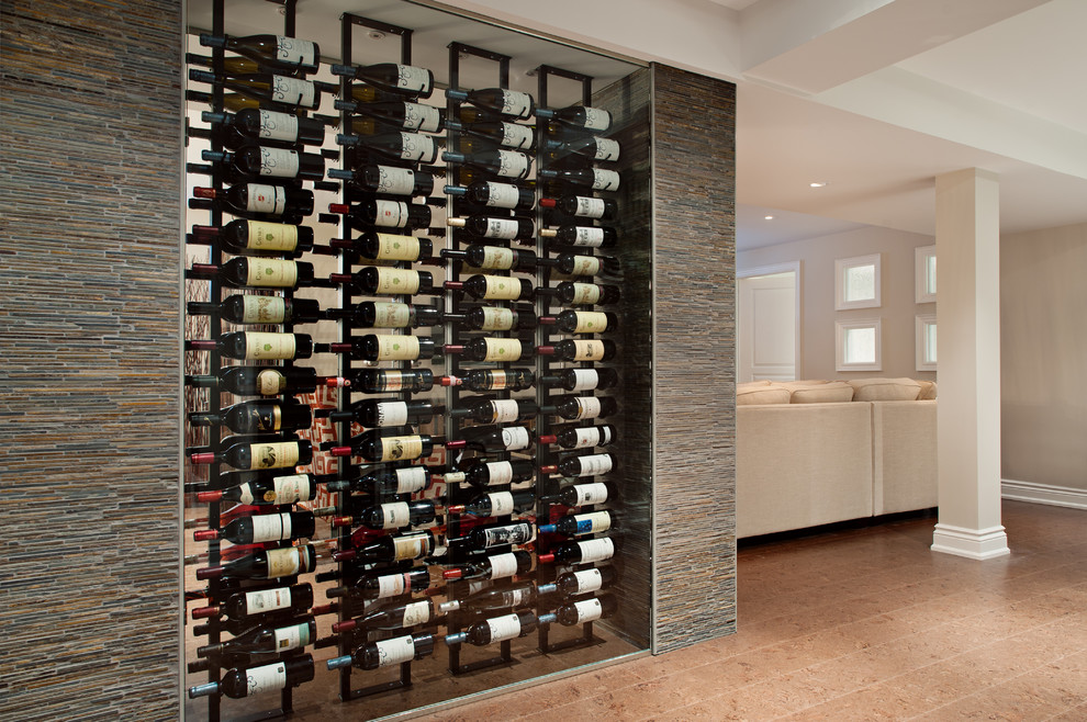 Large contemporary wine cellar in Toronto with cork floors, display racks and beige floor.