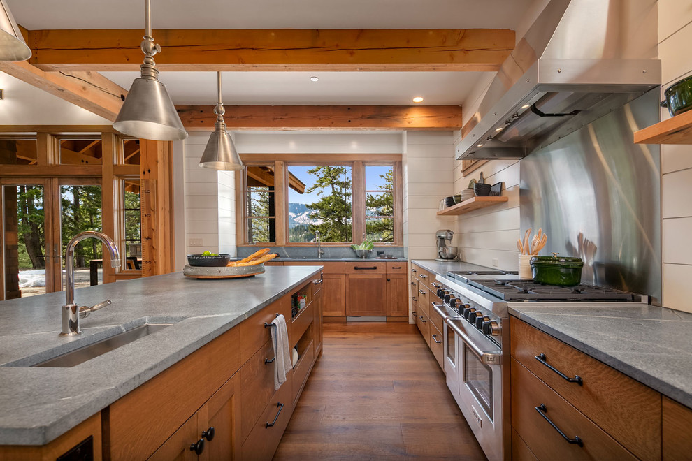 Design ideas for a mid-sized country u-shaped eat-in kitchen in Seattle with an undermount sink, flat-panel cabinets, medium wood cabinets, granite benchtops, white splashback, stainless steel appliances, medium hardwood floors and with island.
