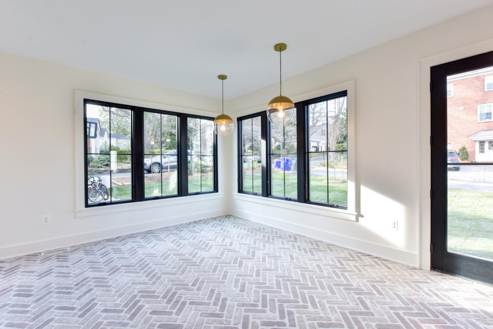 Medium sized contemporary dining room in DC Metro with banquette seating, brick flooring and beige floors.