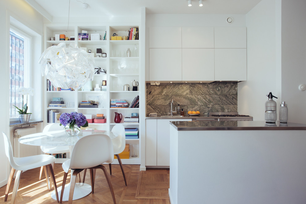Small scandinavian kitchen in Stockholm with flat-panel cabinets, white cabinets and a peninsula.
