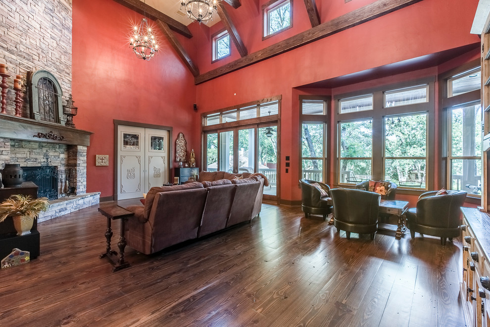 This is an example of an expansive country open concept family room in Dallas with red walls, a standard fireplace and a stone fireplace surround.