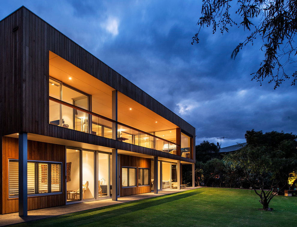 Inspiration for a large contemporary two-storey exterior in Perth with wood siding.