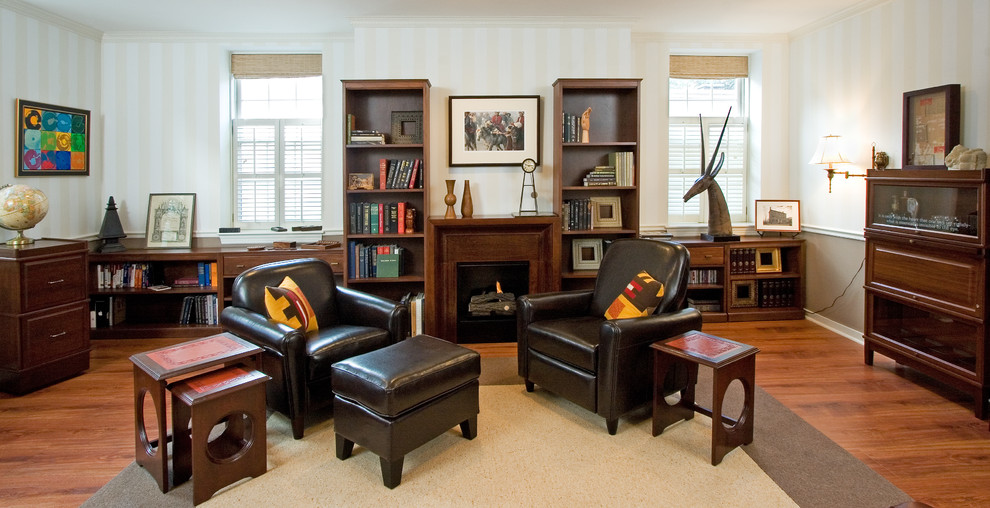 Photo of a contemporary living room in Boston with a library and a wood fireplace surround.