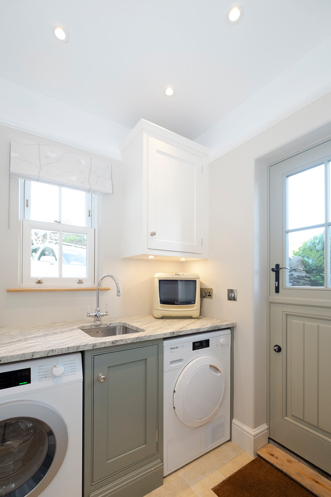 Photo of a small traditional galley separate kitchen in Cardiff with a farmhouse sink, shaker cabinets, green cabinets, granite benchtops, beige floor and grey benchtop.