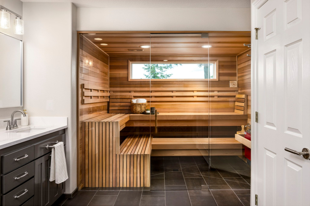Inspiration for a contemporary gray floor and wood wall sauna remodel in Portland with shaker cabinets, gray cabinets, gray walls, an undermount sink, white countertops, a built-in vanity and a hinged shower door