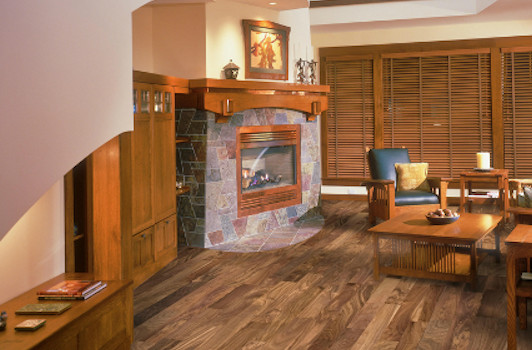 Example of a mid-sized mountain style formal and enclosed dark wood floor and brown floor living room design in Phoenix with beige walls, a standard fireplace, a stone fireplace and no tv
