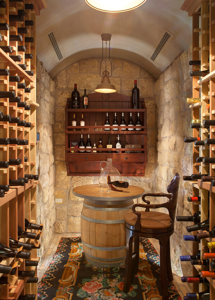 Mediterranean wine cellar in Phoenix with brick floors and storage racks.