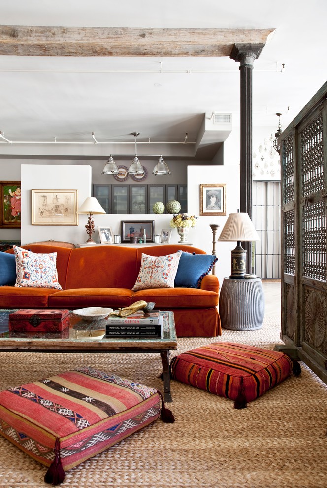 This is an example of an eclectic living room in New York with white walls.