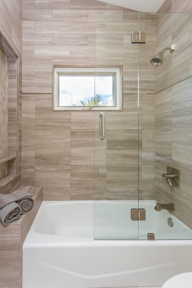 Photo of a mid-sized transitional bathroom in Phoenix with a shower/bathtub combo and gray tile.