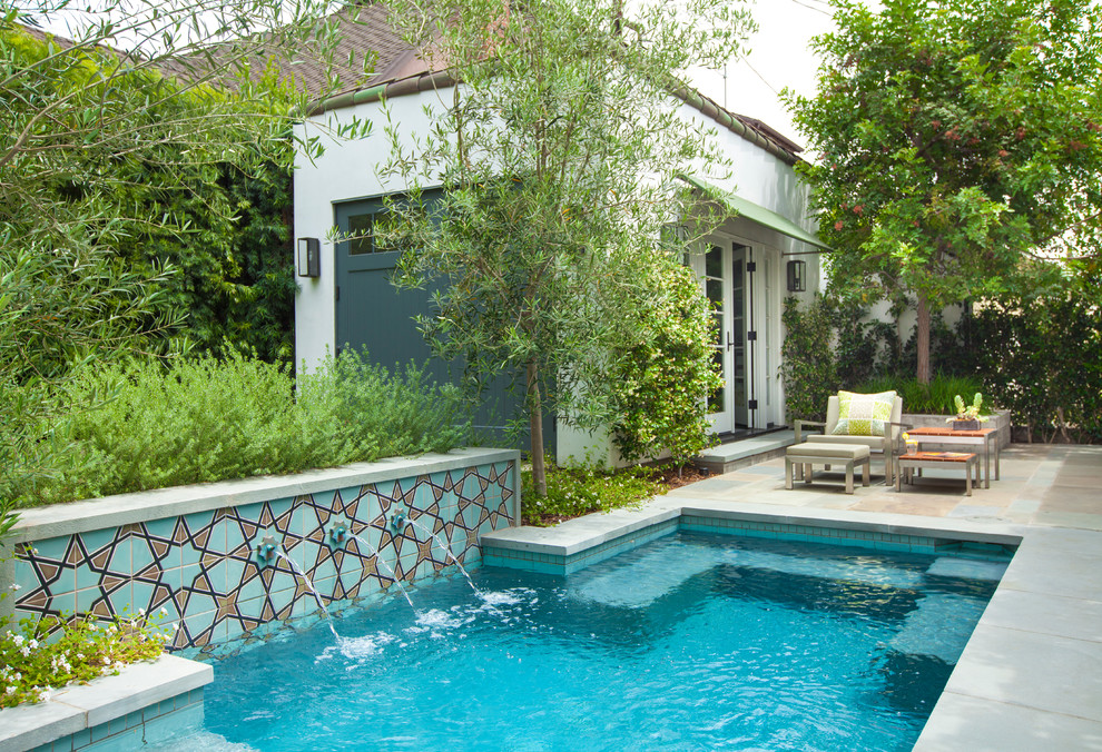 This is an example of a mediterranean rectangular pool in Los Angeles with a water feature.