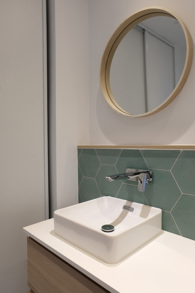 Photo of a contemporary master bathroom in Paris with light wood cabinets, green tile, cement tile, white walls, cement tiles, a drop-in sink, laminate benchtops, green floor and white benchtops.