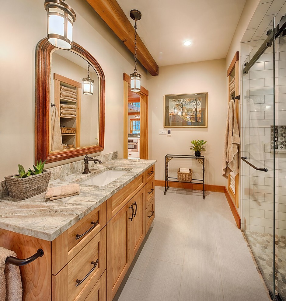 Inspiration for a mid-sized eclectic master bathroom in Burlington with recessed-panel cabinets, light wood cabinets, a curbless shower, white walls, ceramic floors, an undermount sink, terrazzo benchtops and a sliding shower screen.