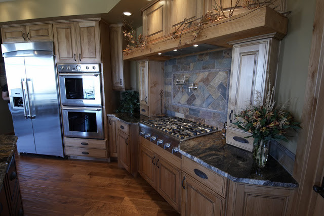 Example of a large mountain style u-shaped medium tone wood floor open concept kitchen design with a double-bowl sink, beaded inset cabinets, medium tone wood cabinets, granite countertops, stainless steel appliances and an island