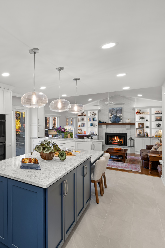 Inspiration for a mid-sized transitional kitchen remodel in DC Metro with shaker cabinets, white cabinets, quartz countertops, porcelain backsplash, stainless steel appliances and an island